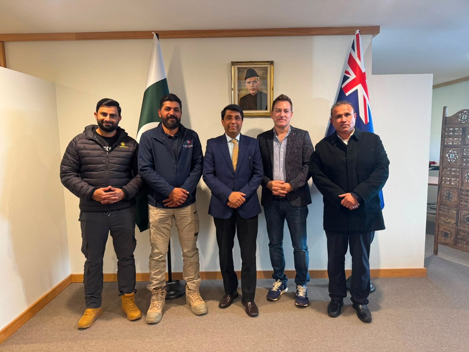 PMA committee members between Pakistan and Australian flags