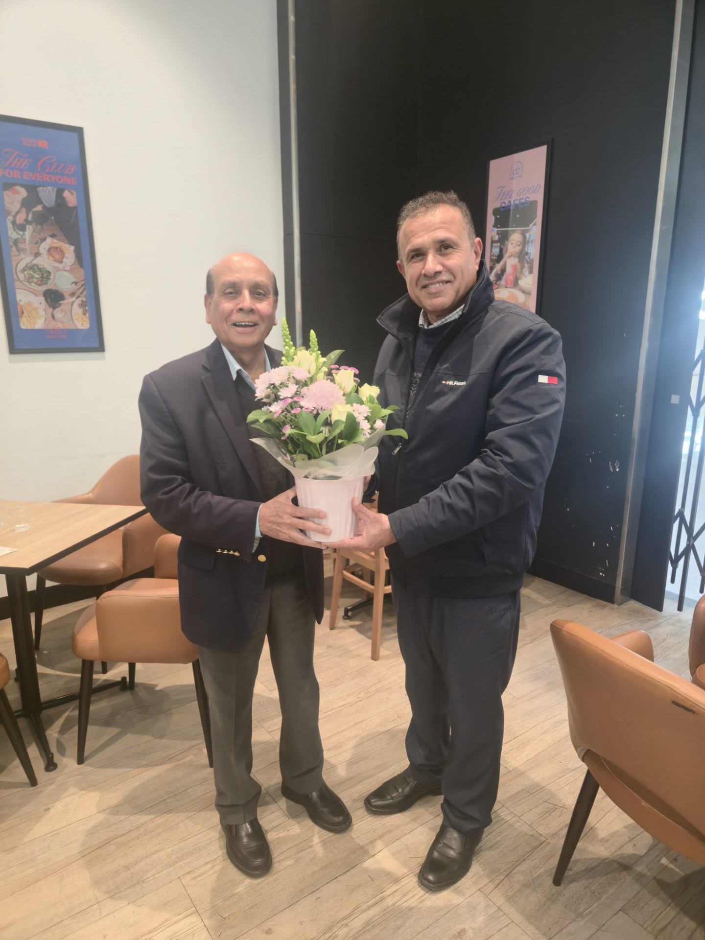PMA members welcoming a community elder with flowers